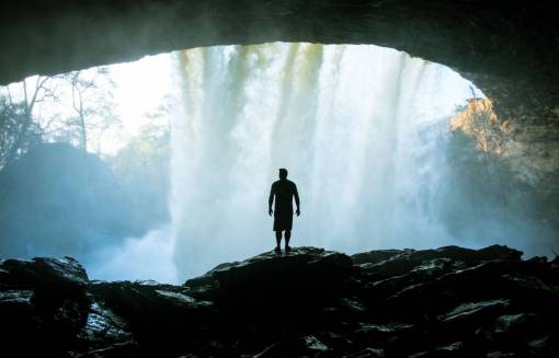 cave people  man  alone  silhouette  rocks  waterfalls  nature