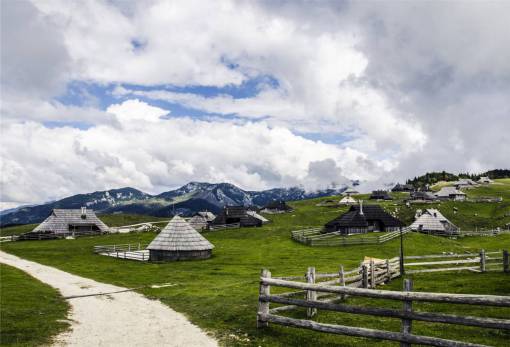 hut stables  huts  fences  grass  rural  sky  clouds
