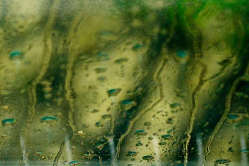 crystal-clear-water background of raindrops on glass at night