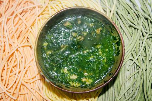 rolling-up-sleeves Colourful Italian pasta tagliatelle with pesto sauce