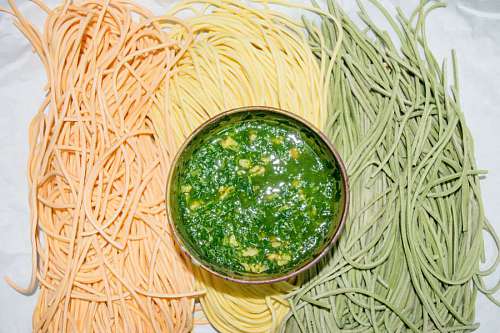 rolling-up-sleeves Colourful Italian pasta tagliatelle with pesto sauce