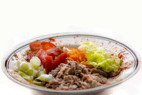 Fresh tuna and vegetables salad on white background, 