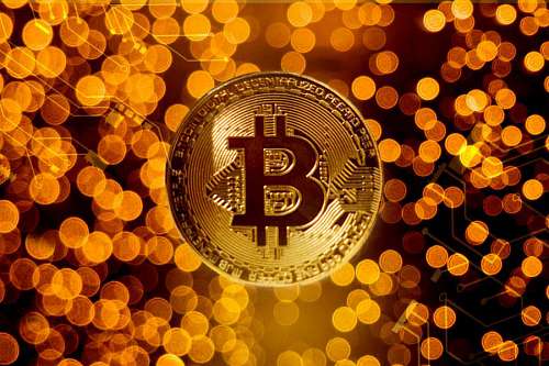 coin Gold bitcoin coin against blur lights background
