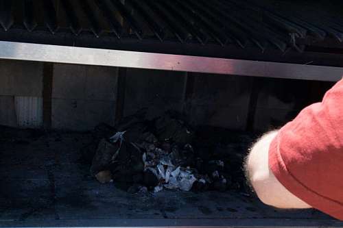 typical Man burning coal to prepare a barbecue