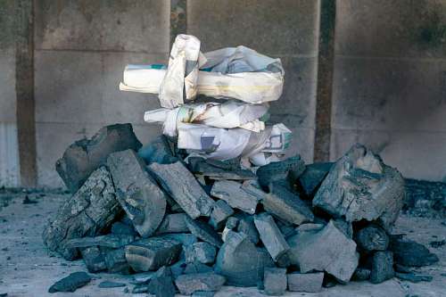 typical Preparing raw coal with newspaper paper for an Argentinean asado barbecue