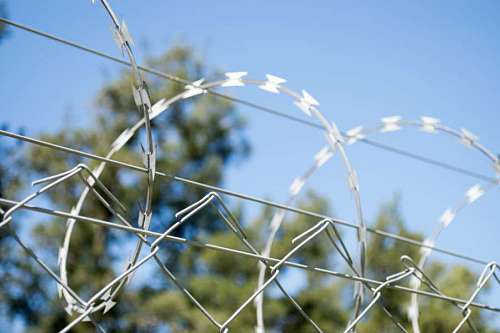 barrier Restricted area - fence with barbed wire