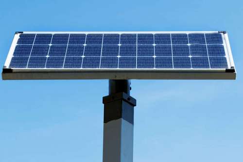 environmental-conservation Solar panel installed in the top of a pole, over the blue sky