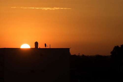 hidden-world The sun is hidden behind the silhouette of the buildings 
