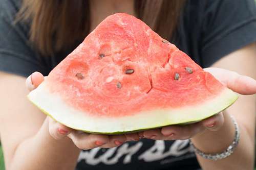 vitality Woman holding watermelon slice