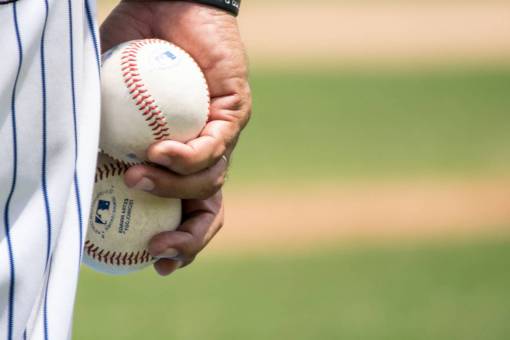 uniform baseball player holding balls