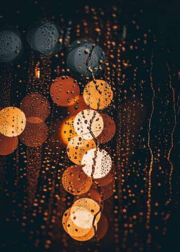 blur lights at night through wet glass