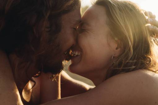 Couple kissing at sunset