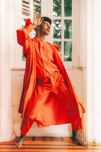 orange Model posing in modern designed orange suit