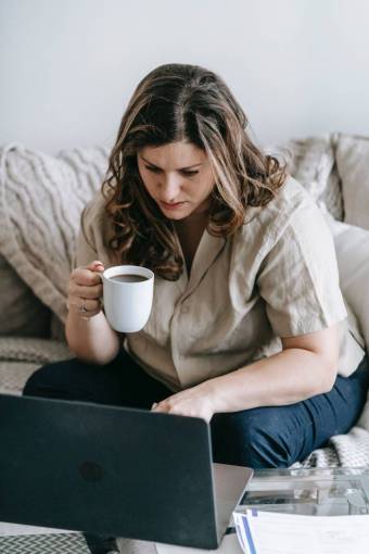 girl Woman working at home and having a cup of coffee