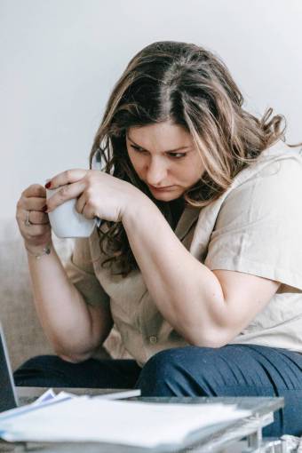 girl Woman working at home and having a cup of coffee