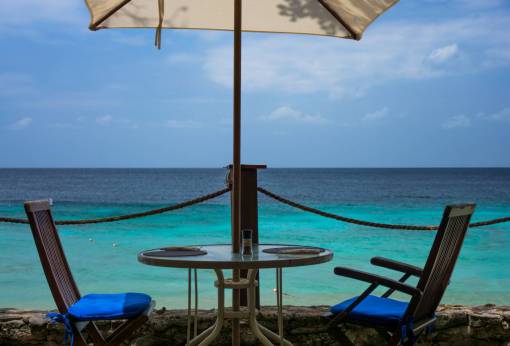 umbrella patio  chairs  table  umbrella  beach  sand  ocean