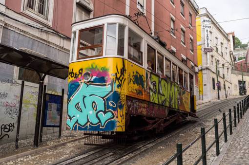 graffiti tramcar  streetcar  trolley  lisbon  graffiti  cobblestone  buildings