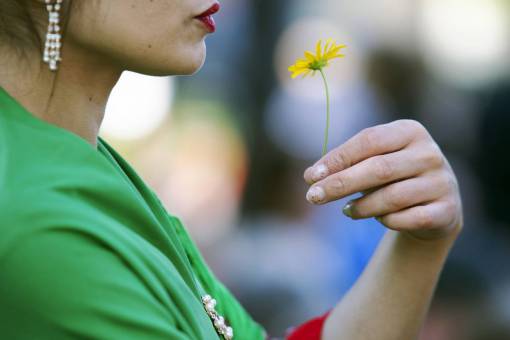 nature Woman Holding a Yellow Flower in Natural Light
