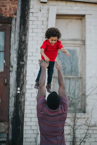 girl Father throwing his daughter up