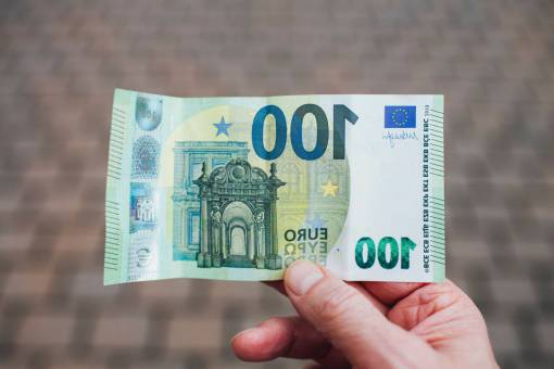 activities Male hand holding 100 Euros Bill