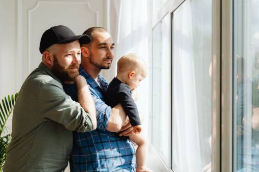 sex-symbol Two men spending time with their little baby boy