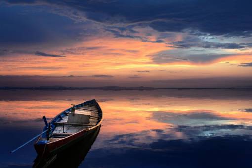Landscape of a boat at sunset on a lake