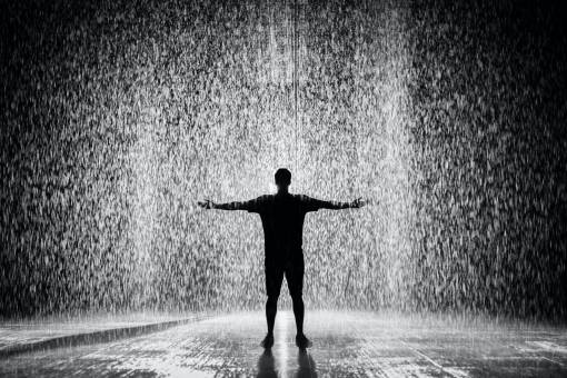 wide-angle Man with open arms in the rain