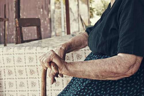 aging-process Elderly woman sitting holding a cane
