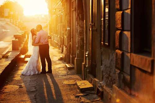 Newlywed couple kissing at sunset