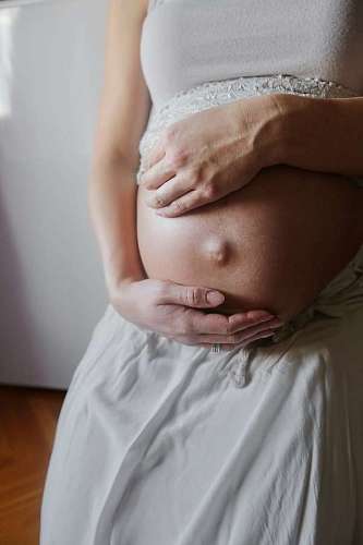 Pregnant woman touching her tummy
