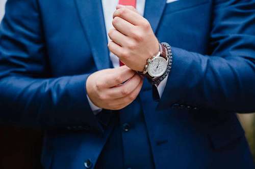 Elegant man in suit adjusting his watch