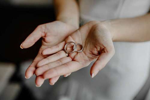 Bride holding wedding rings