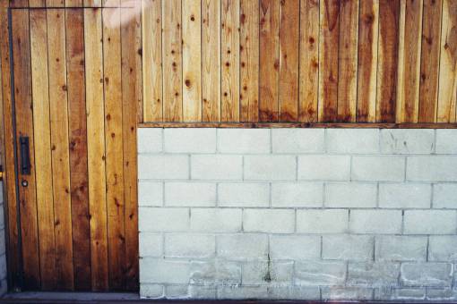 blocks concrete  cinder blocks  wood paneling  door  handle  keyhole  wall
