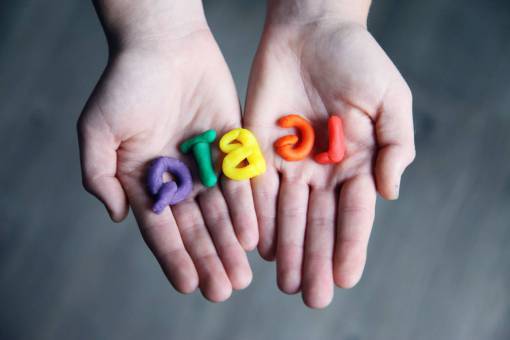 educacion lgbtq;orgullo palabra única mano humana primer plano niño aprendiendo alfabeto