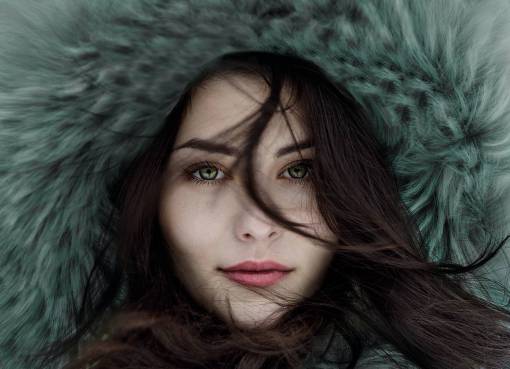 Portrait of green-eyed woman with hair coat