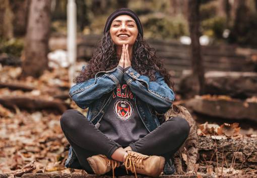 Woman meditating in the forest