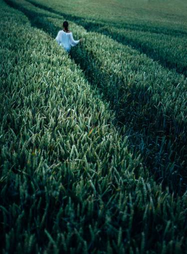 Woman walking in a pasture outdoors