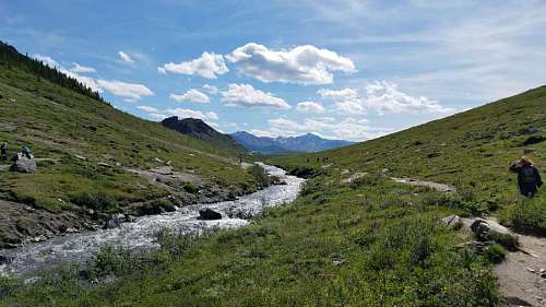 hiker mountain riverbank sky climbing water landscape nature hiker glacier range kb