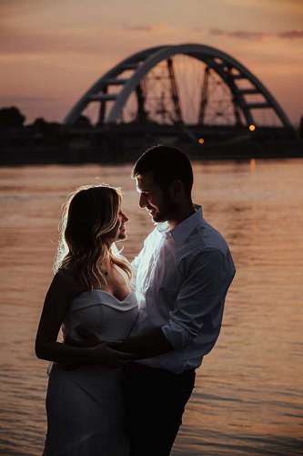 romance couple woman groom sunset water beach