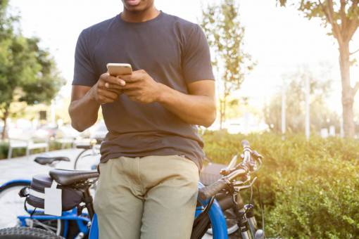 bicycle black man  outside  mobile phone  technology  type  cellphone  bicycle