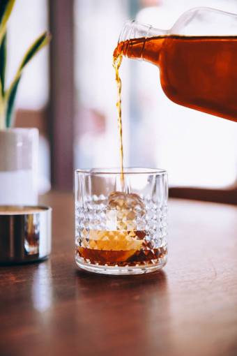 bourbon  pouring  glass  on the rocks  ice  drink  thirsty