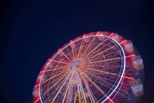 paseo en el parque de atracciones de la feria nocturna del cielo oscuro