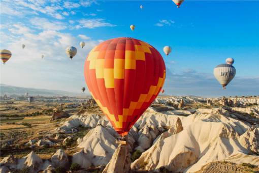 hot air balloons  rocks  cliffs  valleys  fields  landscape
