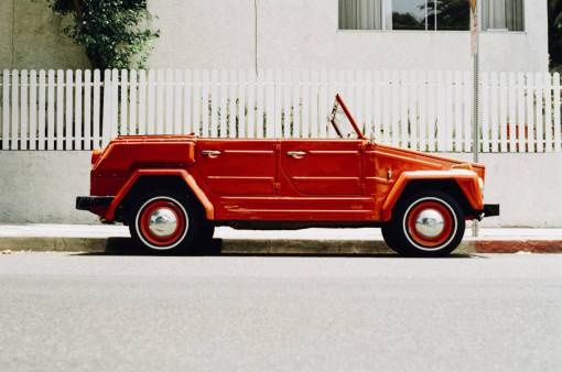 red  car  convertible  wheels  tires  street  sidewalk