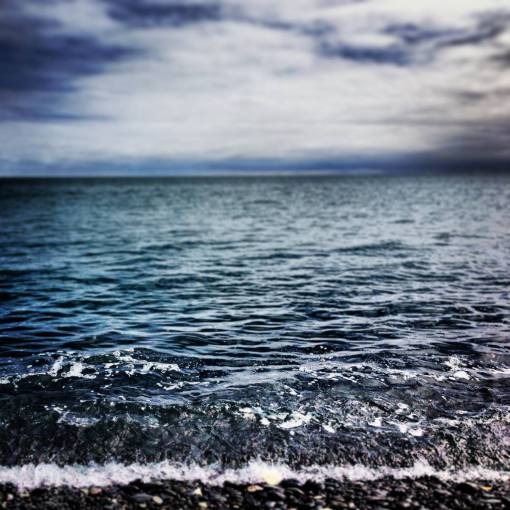 claro cielo azul claro agua olas piedras mar