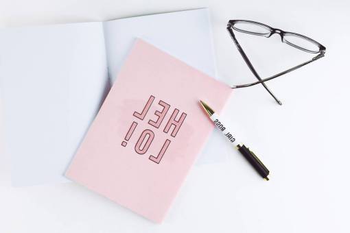 feminine flat lay  card  glasses  writing  pen  notebook  desk