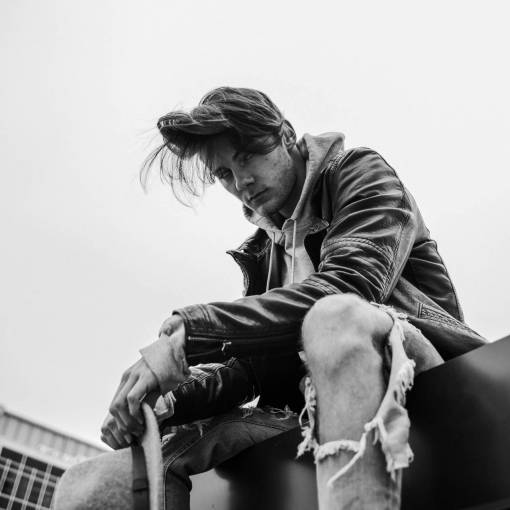 knees man  guy  male  black and white  ripped  jeans  sky