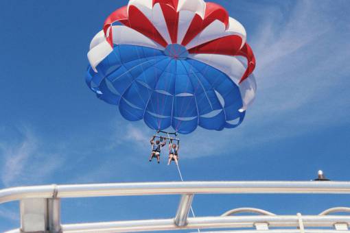 parachute parachute  blue  sky  clouds  people  man  woman