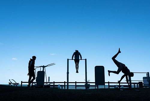 gymnastics Gymnasts doing sport outdoors on the beach