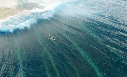 A person surfing, drone pov